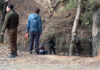 NIA sleuths and police personnel during searches at Hutmurah forest in Anantnag on Tuesday. -Excelsior/Sajad Dar