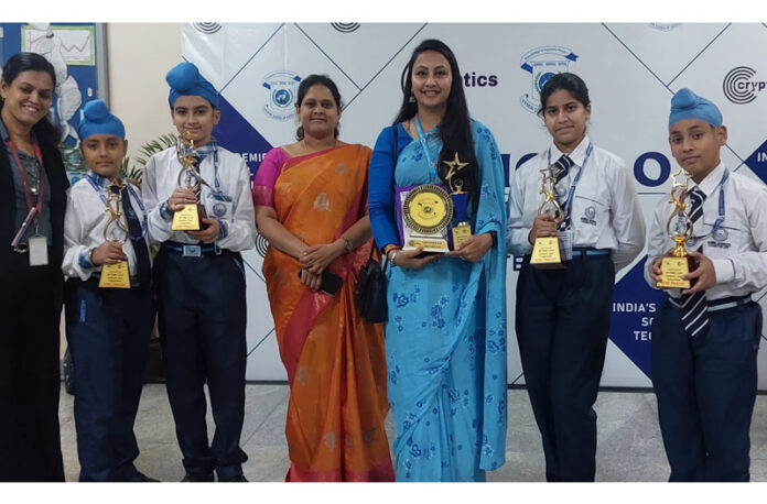 Students posing along with school management.
