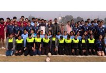 Handball players posing along with college management.