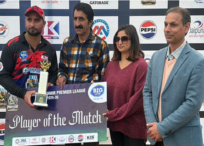 Player receiving man of match cheque from dignitary.