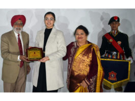Dignitary presenting scholarship to a student.