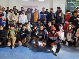 Winners posing along with medals and dignitaries.