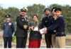 Cadets receiving trophy from dignitaries.