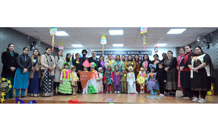Dignitaries posing along with students during a programme.