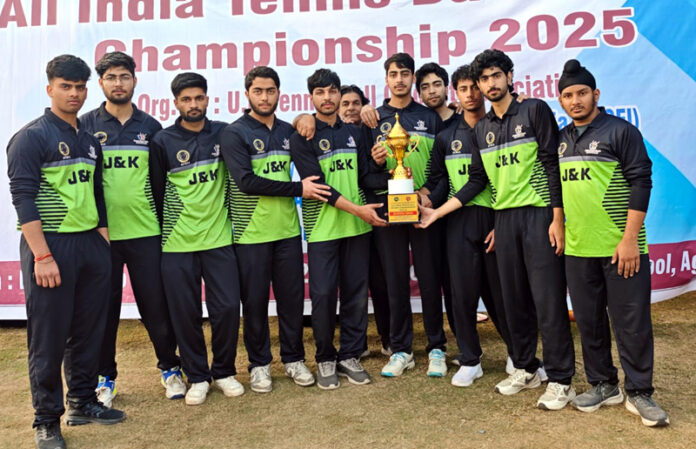 Winning team posing along with trophy.