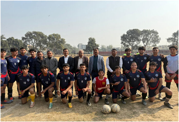 Dignitaries posing along with football players during a match.