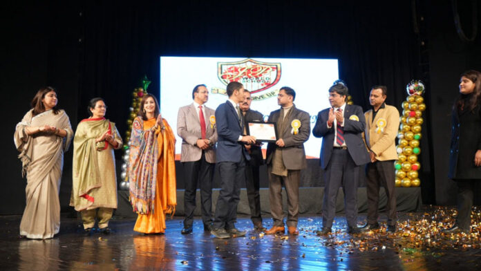 Dignitaries presenting certificate to a student during a programme.