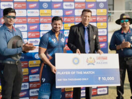 Player of match receiving cheque from dignitary.