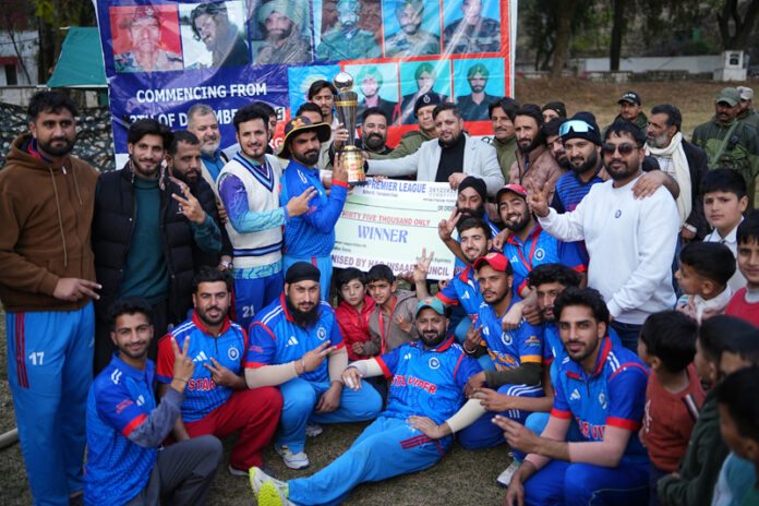 Winning team posing along with trophy and dignitaries.