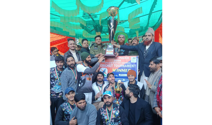 Winning team posing along with trophy during prize distribution ceremony.
