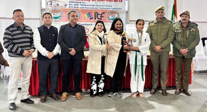 Dignitary presenting trophy to winner during a programme.