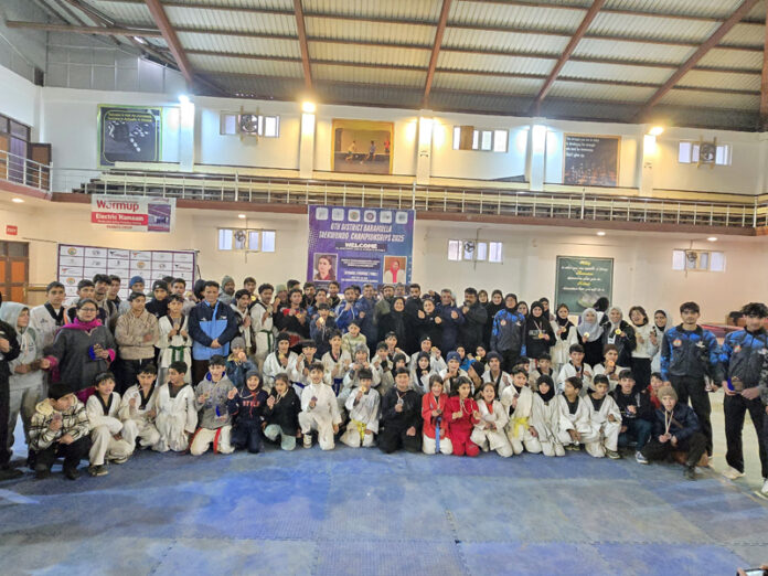 Participants posing with guests during valedictory function of District Baramulla Taekwondo Championship.