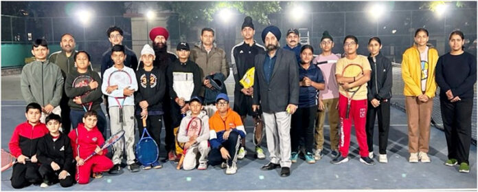 Budding tennis players posing along with a dignitary during an event. Budding tennis players posing along with a dignitary during an event.