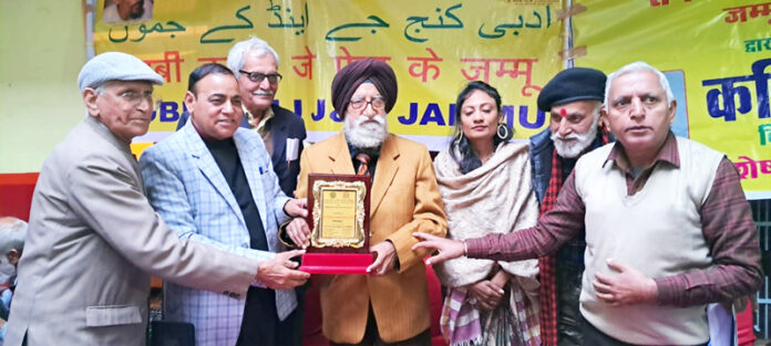 A literary personality being felicitated with a memento during an event organized by Adbi Kunj in Jammu on Monday.