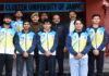 Men's Badminton team posing along with dignitaries.