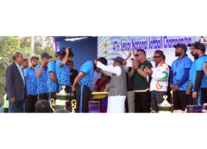 Dignitary presenting medal to Softball player during prize distribution ceremony.