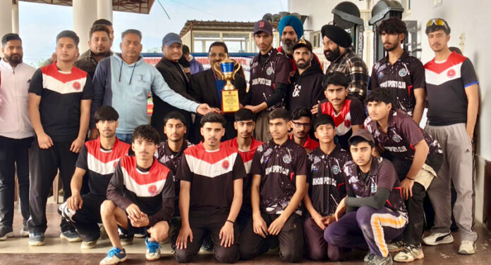 Winning team posing along with trophy. Winning team posing along with trophy.