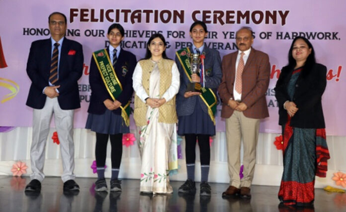 Dignitary posing along with students and school management. Dignitary posing along with students and school management.