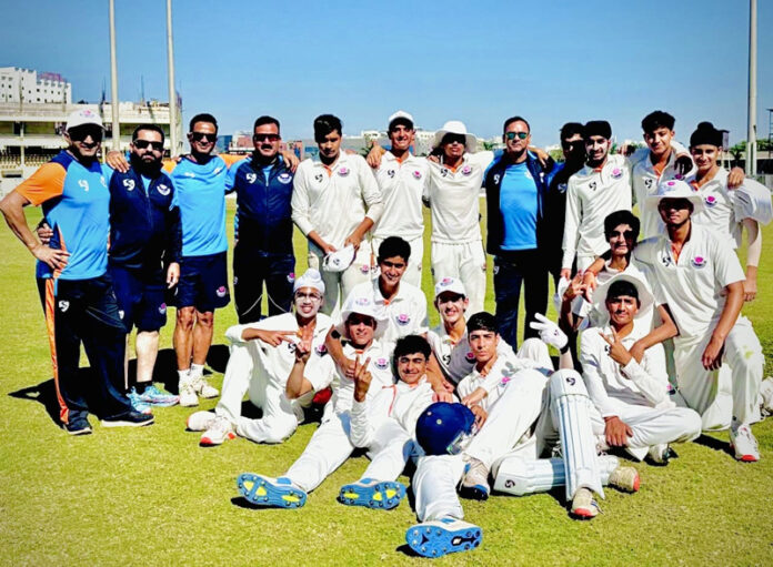 Winning team posing along with support staff.
