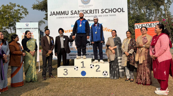 Winners posing with medals on podium during Special Sports Day event.