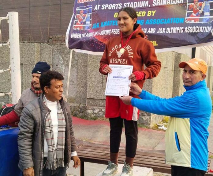 Winner on podium posing along with certificate and dignitaries. Winner on podium posing along with certificate and dignitaries.