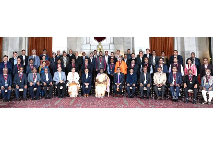 President of India, Droupadi Murmu, flanked by Union Minister Dr Jitendra Singh, posing for group photograph with the recipients of “Rashtriya Vigyan Puraskar 2025” at Rashtrapati Bhavan, New Delhi on Tuesday.