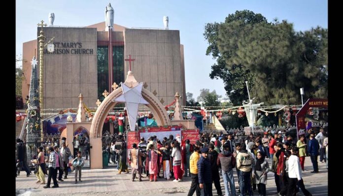 People during celebration of Christmas at Gandhi Nagar Church on Thursday. -Excelsior/Rakesh
