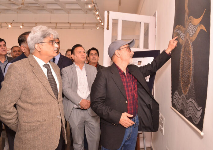 CS being briefed about a painting at an exhibition at Kala Kendra Jammu on Friday.