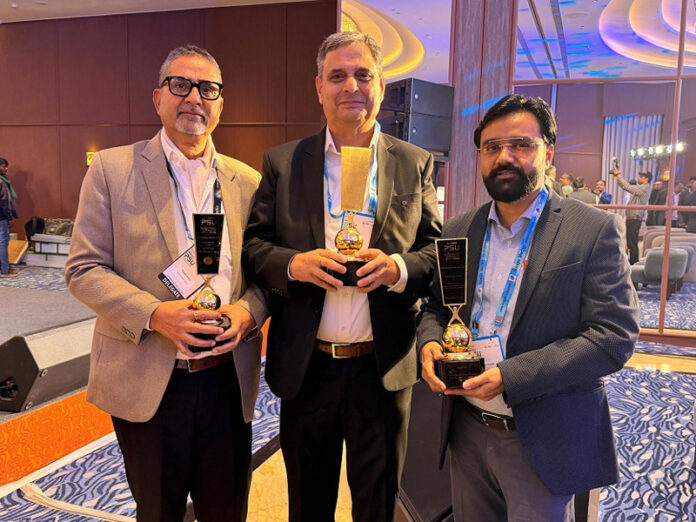 A representative of JSCL posing with others after receiving award.