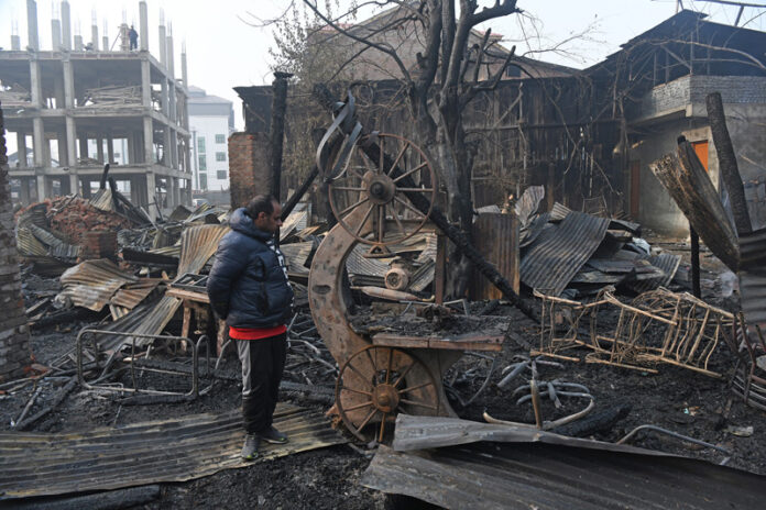 Midnight blaze destroys timber units, commercial building in Srinagar’s Munawarabad area. — Excelsior/Shakeel