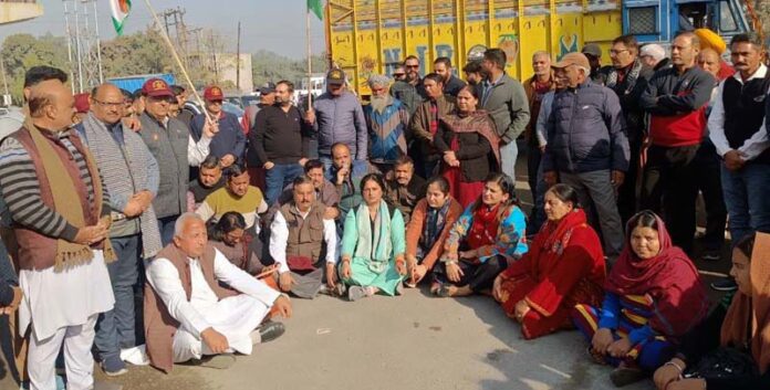 Sangharsh Samiti activists block road during protest at Jammu on Wednesday. -Excelsior/Rakesh