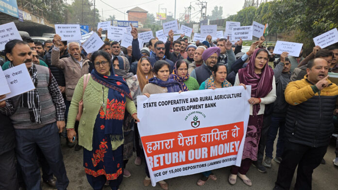 SCARD Bank depositors protesting in favour of their demands at Indira Chowk in Jammu on Monday. — Excelsior/Rakesh