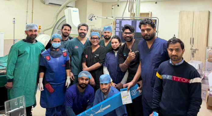 Dr Nikhil Mahajan posing with his medical team after performing implantation of a leadless pacemaker on a patient at KD Hospital, Jammu.