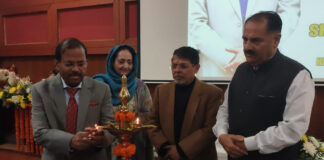 Dignitaries lighting the traditional lamp during a function in Jammu.
