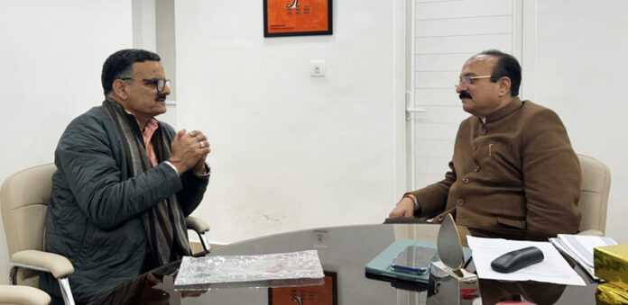 Sanjay Baru during his meeting with Delhi Minister Ashish Sood on Monday.