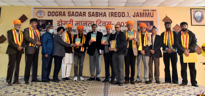 Dogri litterateurs being honoured by Dogra Sadar Sabha during Dogri Manyata Divas celebration on Saturday.