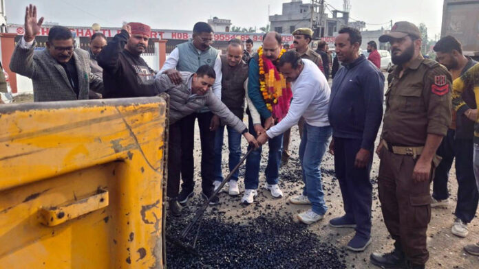 MLA Bishnah Dr Rajiv Kumar Bhagat kick starting macadamization of road in his constituency on Wednesday.