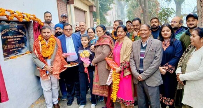 MLA Bharat Bhushan posing for a photograph after dedicating a road to the people in Patel Nagar.