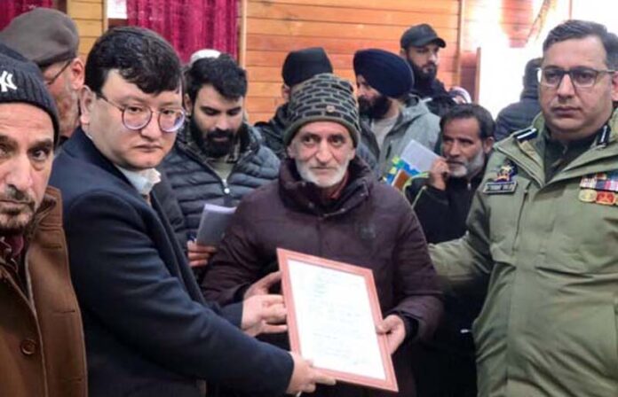 DC Baramulla handing over sanction letter under PMAY-U to a beneficiary on Friday. DC Baramulla handing over sanction letter under PMAY-U to a beneficiary on Friday.