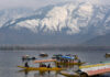 Tourists enjoying Shikara ride in Dal at the foothills of snow covered mountains in Srinagar. Another pic on page 4. -Excelsior/Shakeel