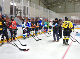 Officials posing along with Ice Hockey players during trials.