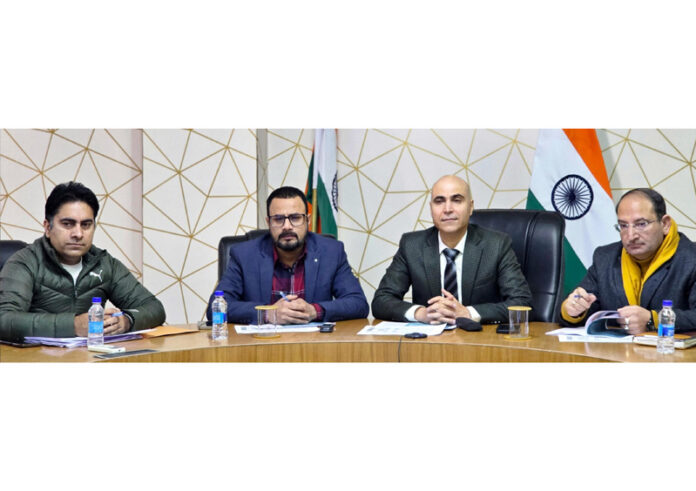 DC Pankaj Kumar Sharma chairing a meeting at Kishtwar on Sunday.