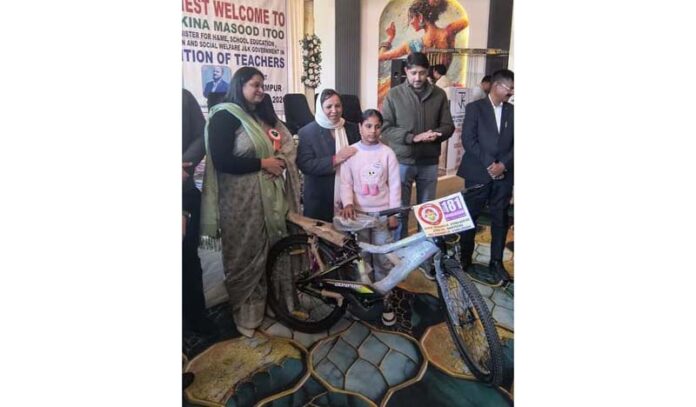 Minister Sakeena Itoo bicycle to a child for outstanding performance in National sports events.