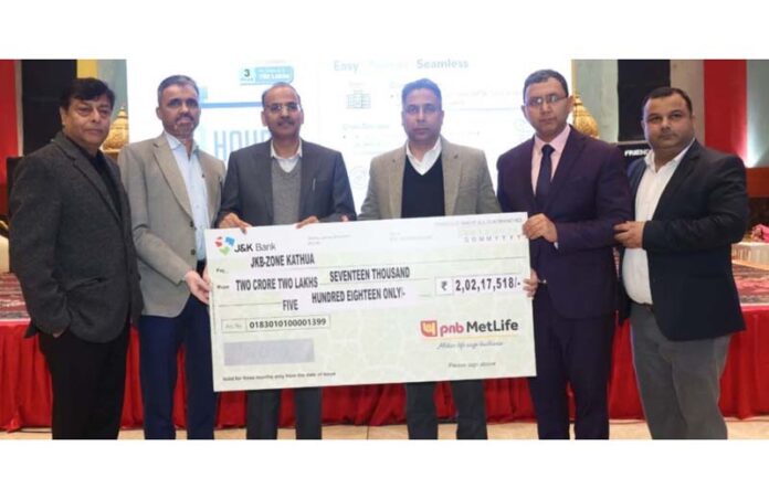 J&K Bank’s Zonal Head (Kathua) Suresh Kumar Chowdhary along with others displaying a symbolic cheque representing the total amount of insurance claim settled. J&K Bank’s Zonal Head (Kathua) Suresh Kumar Chowdhary along with others displaying a symbolic cheque representing the total amount of insurance claim settled.