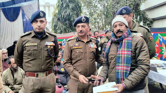 SSP Jammu Joginder Singh handing over a lost phone to its rightful owner at DPL Jammu on Wednesday.