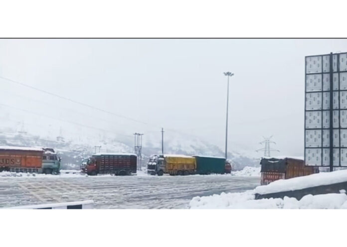 Trucks stranded near Banihal on Jammu-Srinagar National Highway on Tuesday. -Excelsior/Parvez