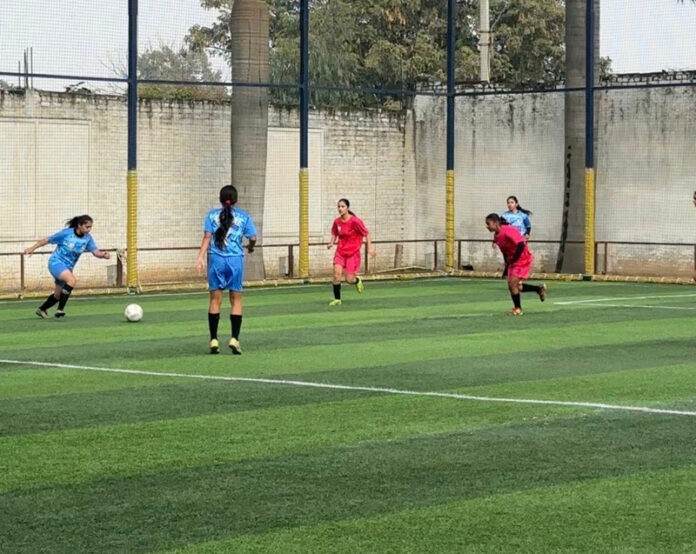 Girl footballers in action during a match. Girl footballers in action during a match.