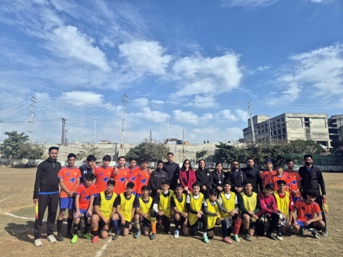 Football players posing along with dignitaries.