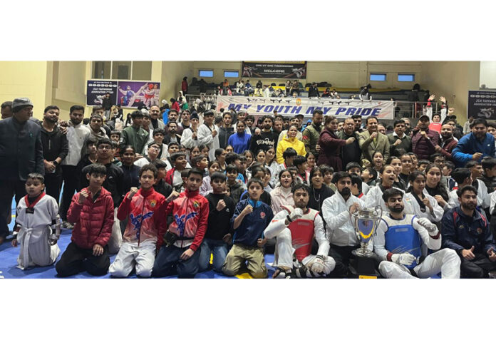 Winners posing along with medals and dignitaries during prize distribution ceremony.