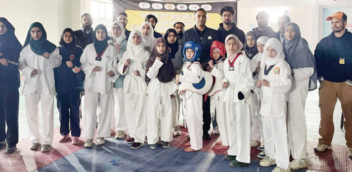 Taekwondo players posing with guests and officials at Indoor Stadium, Shadipora in Bandipora district.